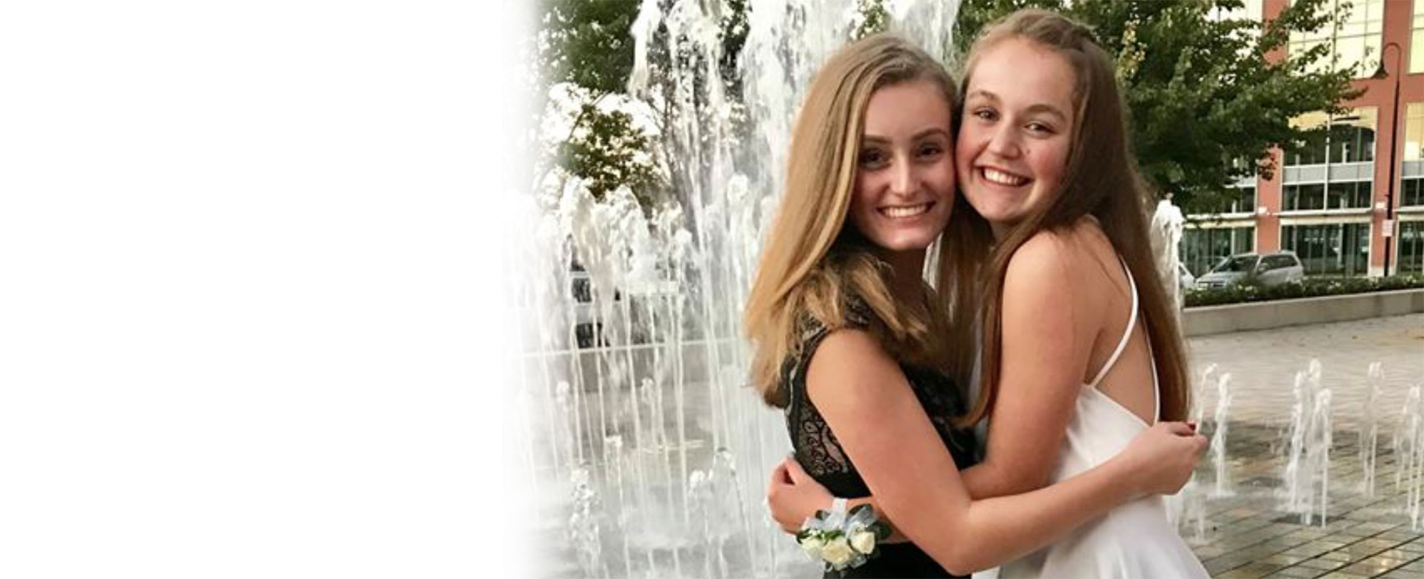 Girls hugging at fountain